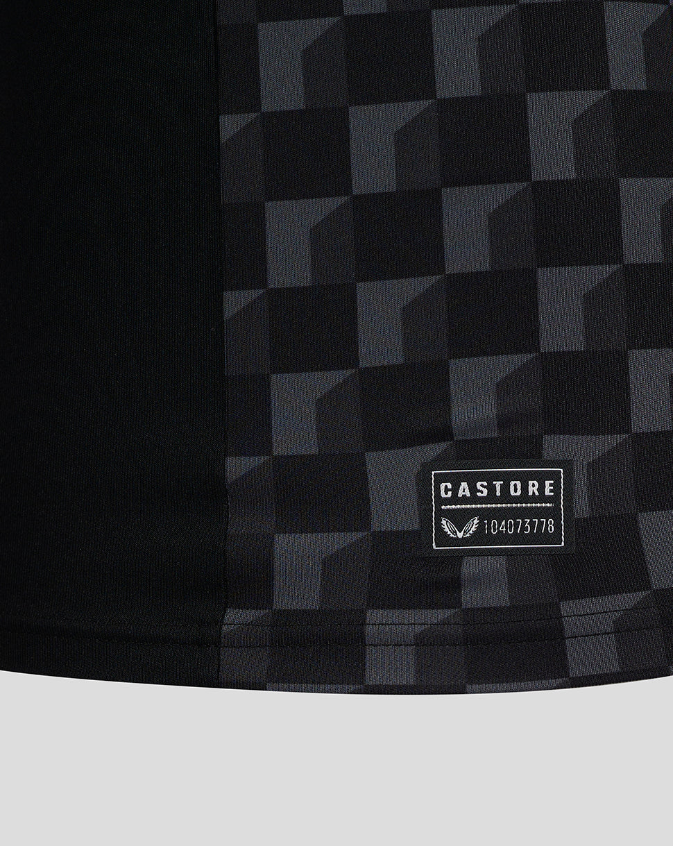 Close-up of the Mansfield shirt fabric showing a dark checkered pattern and CASTORE patch.