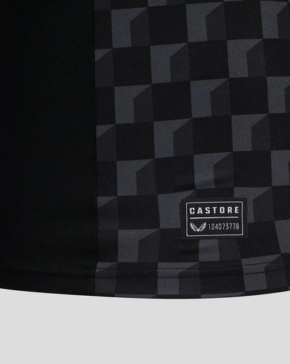Close-up of the Mansfield shirt fabric showing a dark checkered pattern and CASTORE patch.