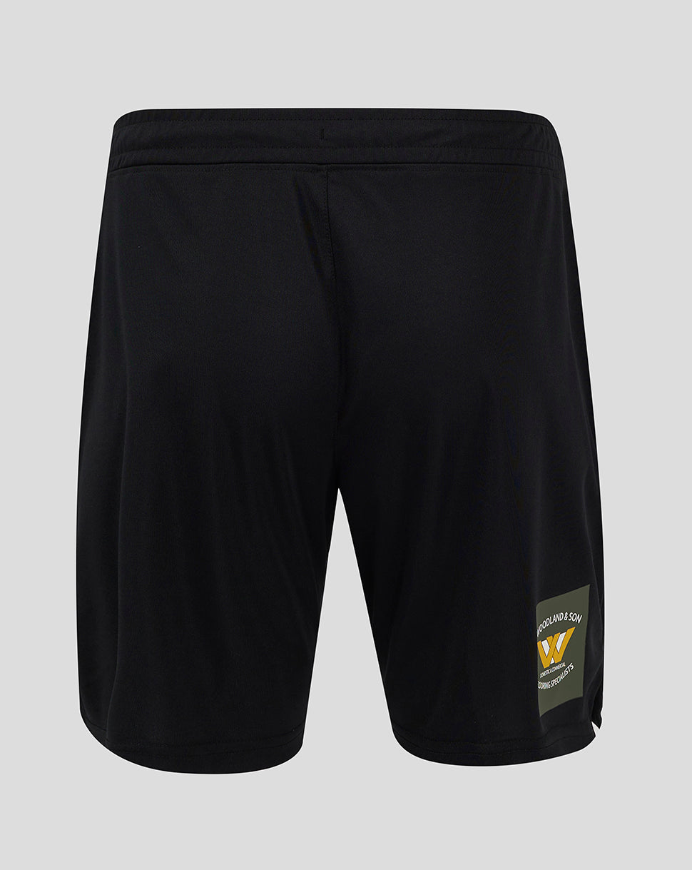 Back view of black Mansfield Third Shorts with a logo patch on the lower right leg.