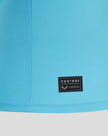 Close-up of turquoise Mansfield goalkeeper shirt fabric with a Castore patch at the hem