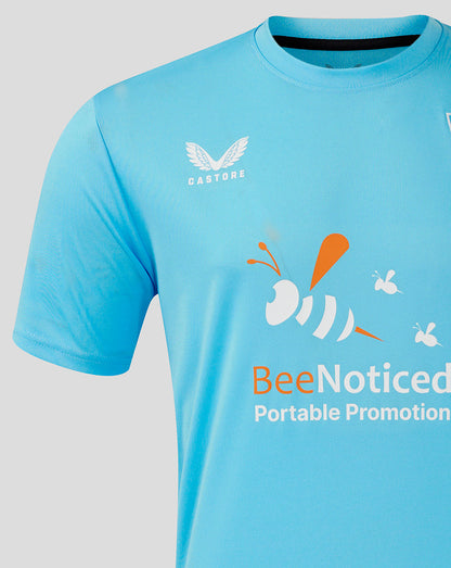 Close-up of a light blue Mansfield Third Goalkeeper shirt with Castore branding on the chest and a BeeNoticed graphic across the front