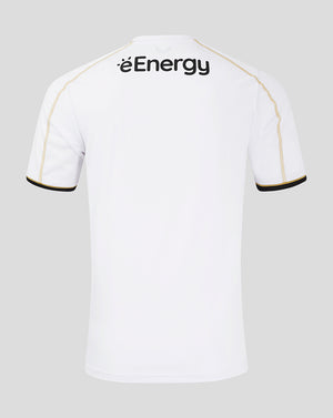 Back view of white MK Dons home shirt with gold piping along the shoulders and black cuff trim