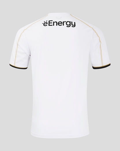 Back view of white MK Dons home shirt with gold piping along the shoulders and black cuff trim