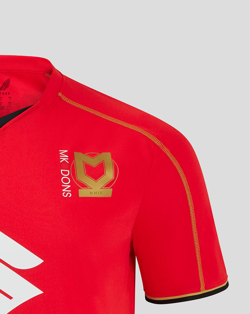 Mk Dons red away shirt featuring a gold crest on the chest and vertical Mk Dons branding.