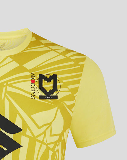 Shoulder and chest close-up of Mk Dons away goalkeeper shirt with bold geometric print crest and Mk Dons lettering