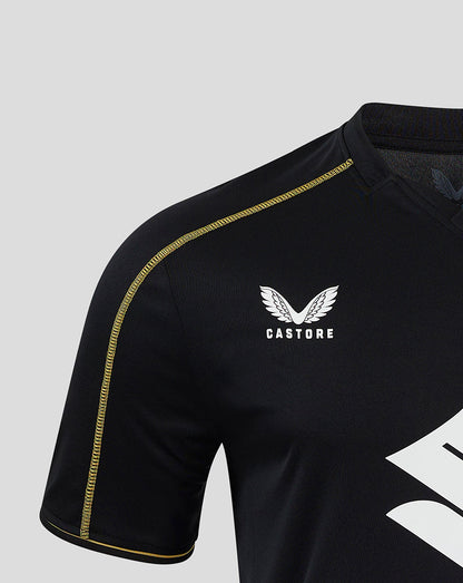 Close up of the shoulder and chest on Mk Dons 24/25 third shirt with Castore logo and gold piping detail