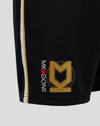 Close up of black Mk Dons 24/25 third shorts with white and gold side piping and gold crest.