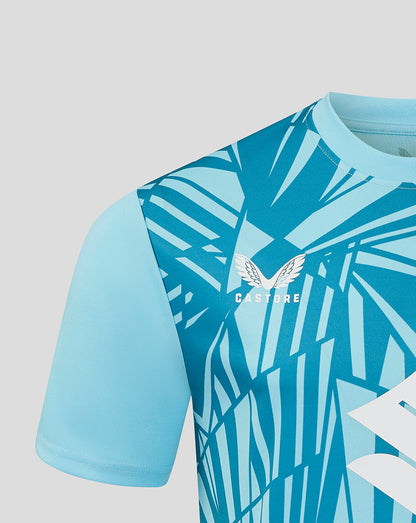 Close up of Mk Dons 24/25 third goalkeeper shirt in turquoise blue with geometric print and crest.
