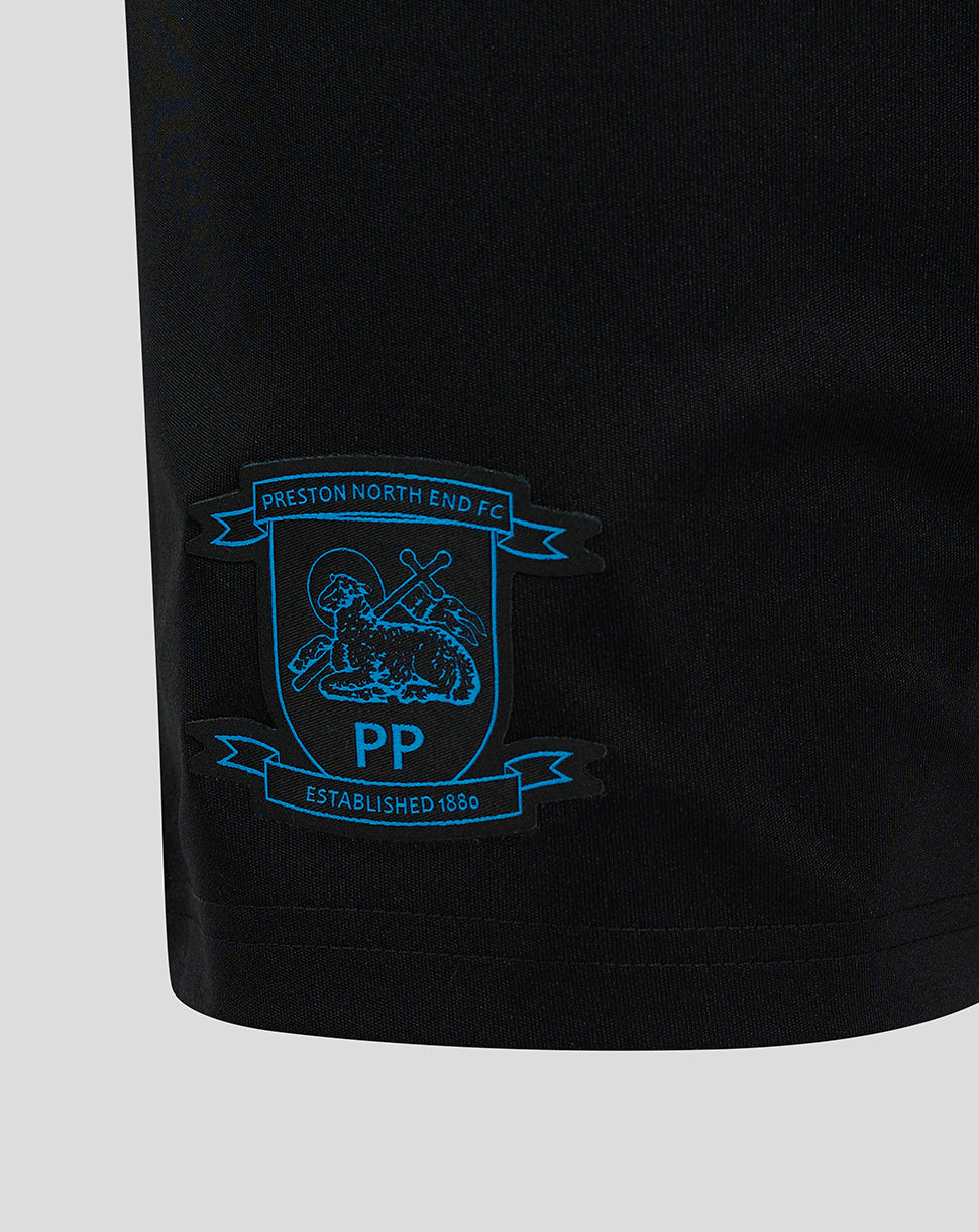Close-up view of blue Preston North End club crest on black shorts.