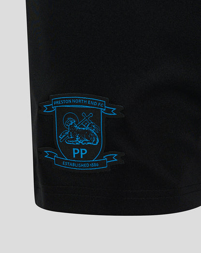 Close-up view of blue Preston North End club crest on black shorts.
