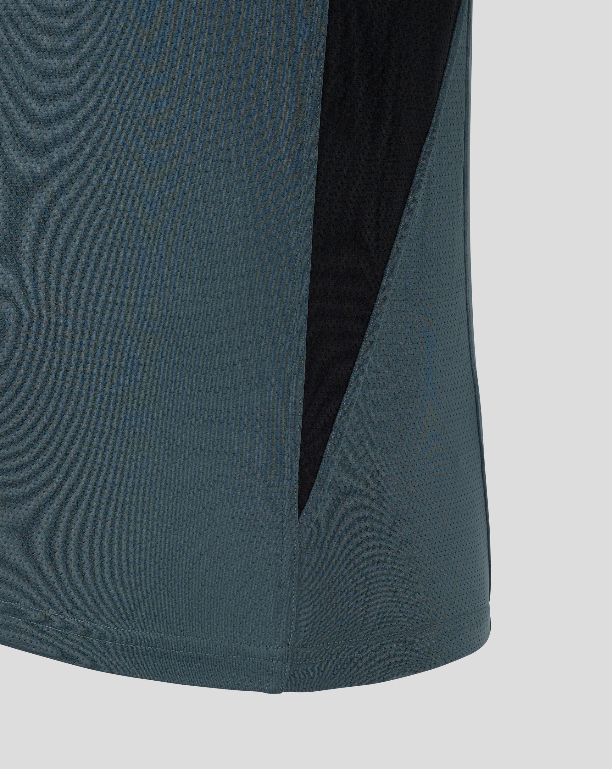 Close up of Bath Rugby training long sleeve shirt fabric in teal with a black side panel.