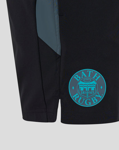 Close up of black Bath Rugby shorts with teal side panel and turquoise circular Bath Rugby crest on the thigh.