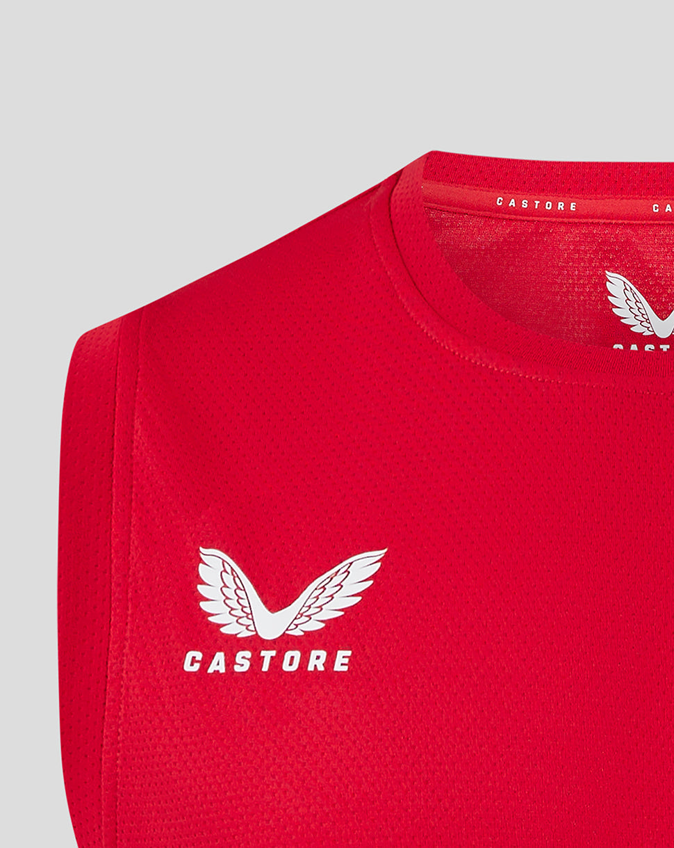 Close-up of red vest showing Castore branding with a large white Castore logo on the chest.