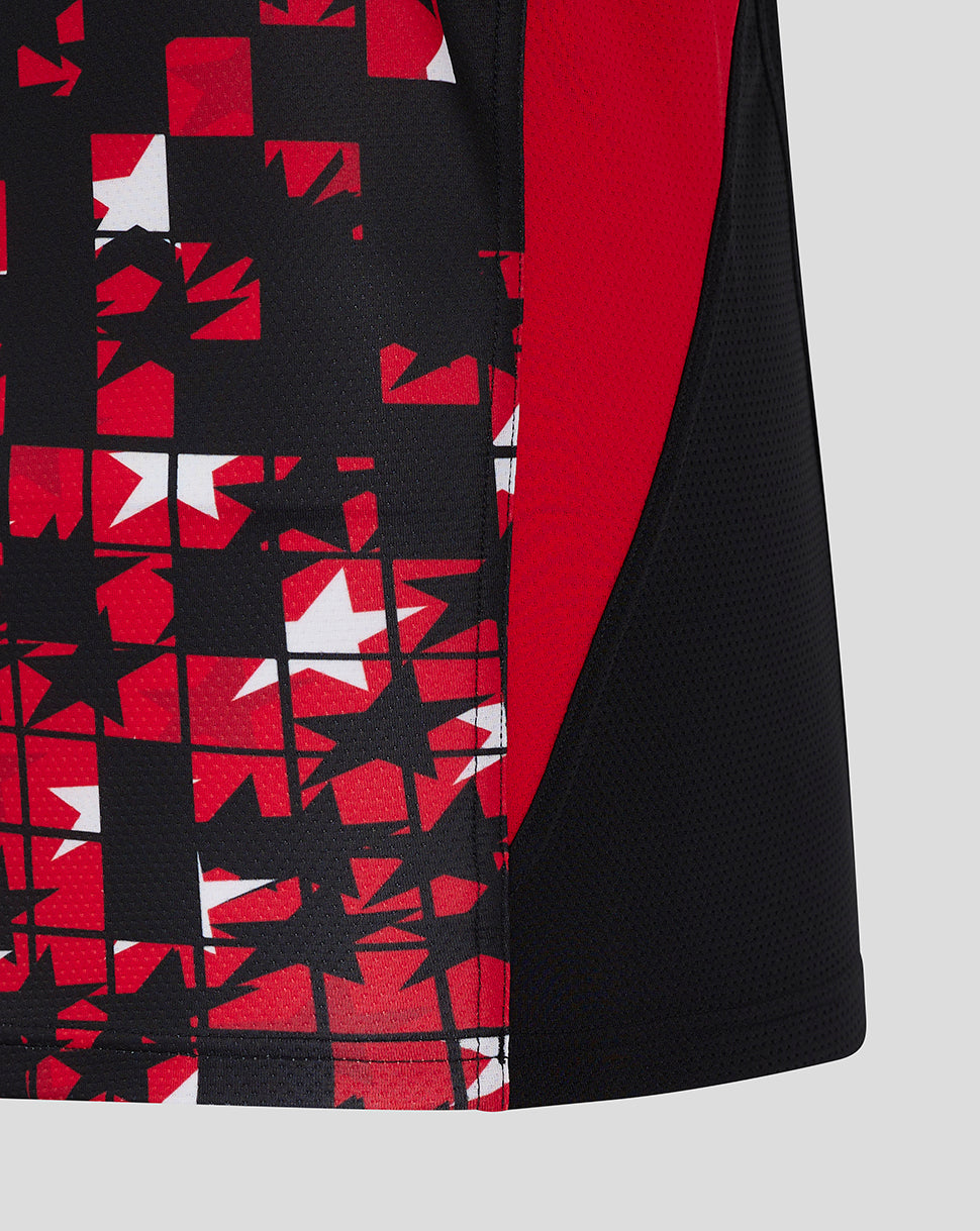 Lower front of black vest with red geometric patchwork and a red side panel