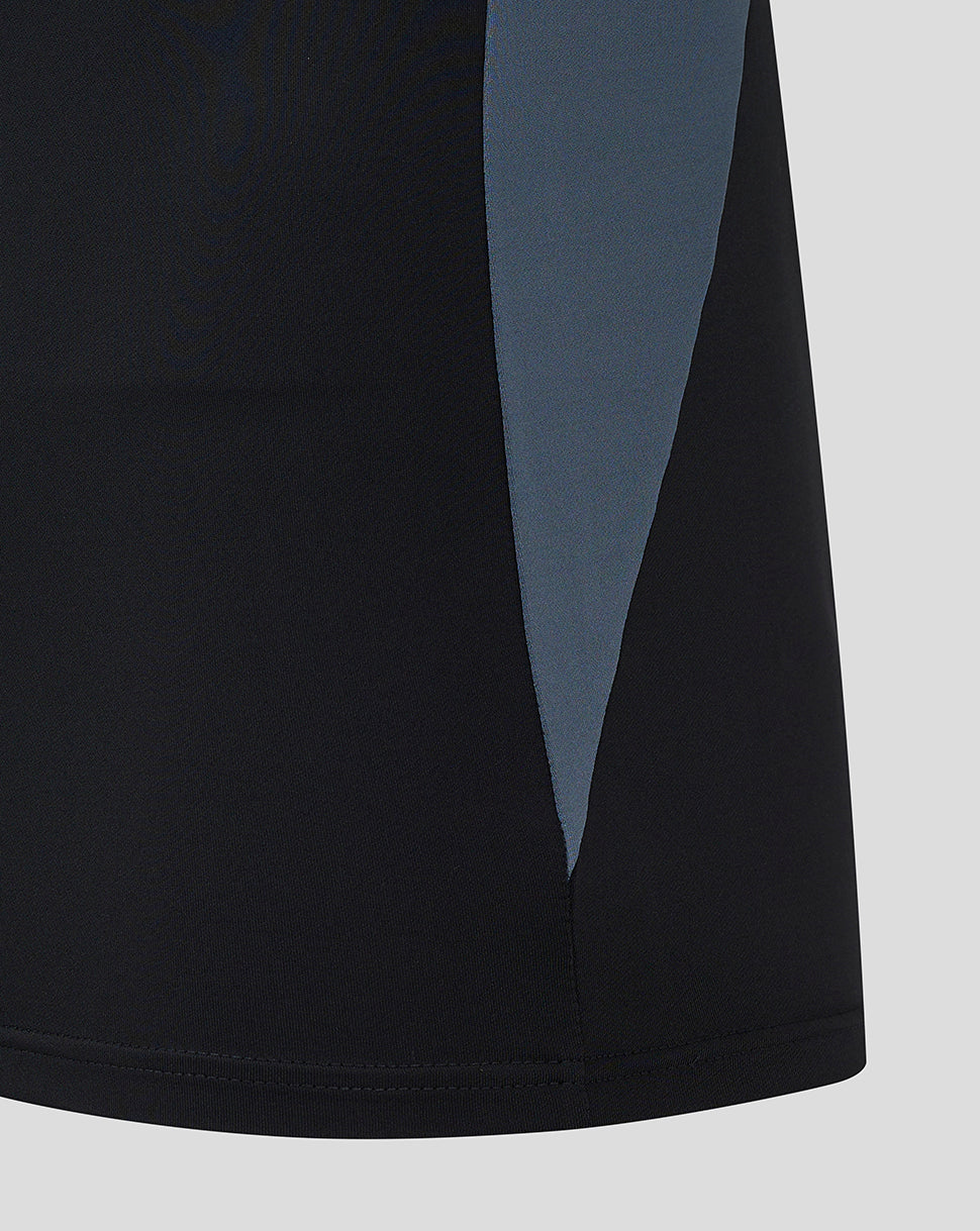 Lower side view of black Saracens training top with a blue colorblock panel.