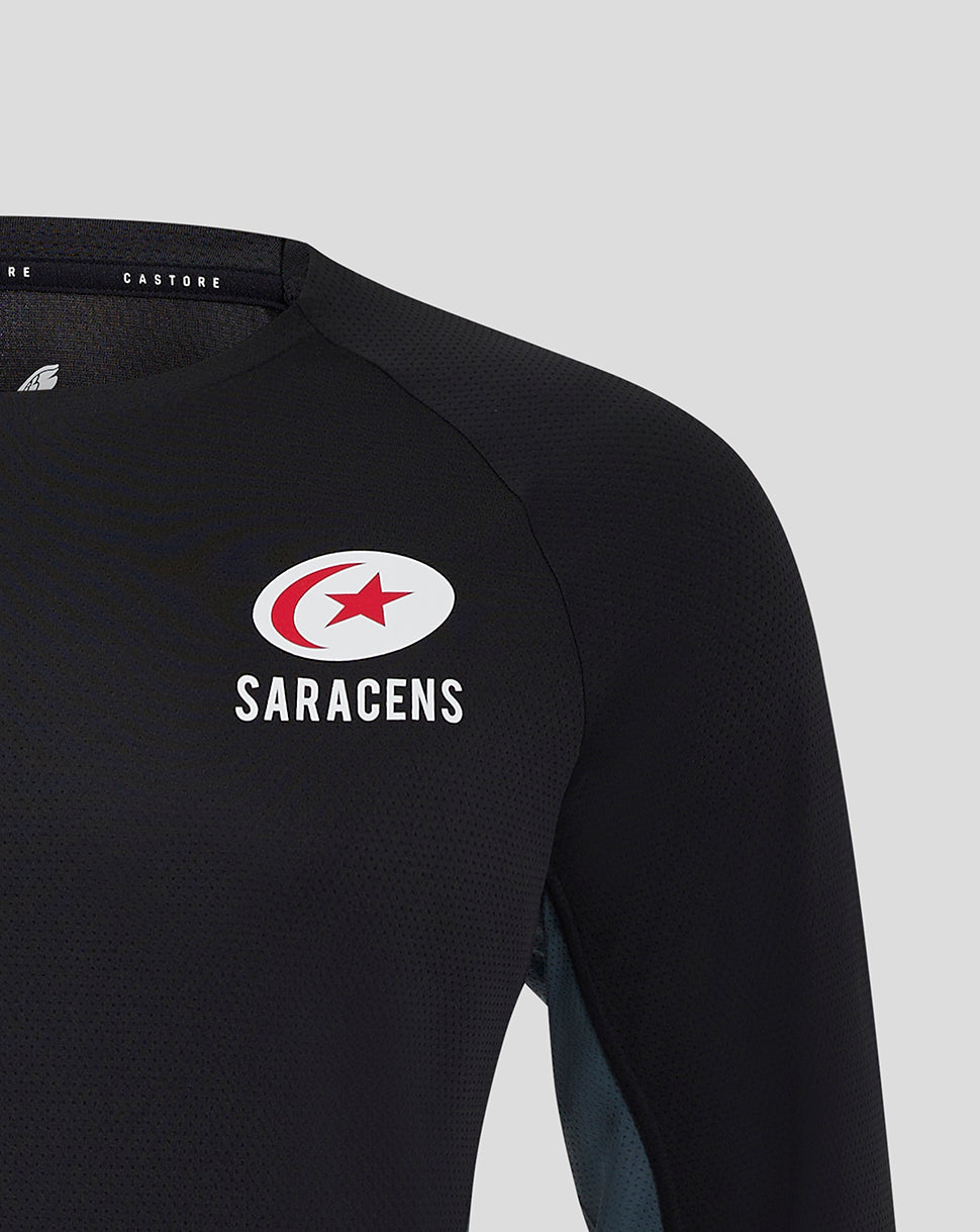 Close-up of chest area on black Saracens training tee showing Castore logo and Saracens crest
