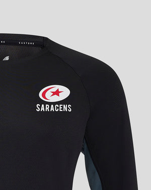 Close-up of chest area on black Saracens training tee showing Castore logo and Saracens crest