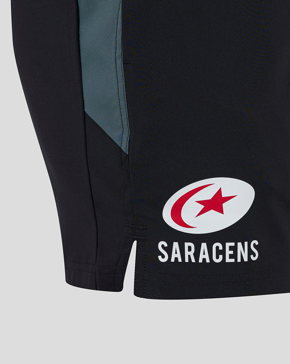 Side view of black Saracens training shorts with teal side panels and a white logo on the leg