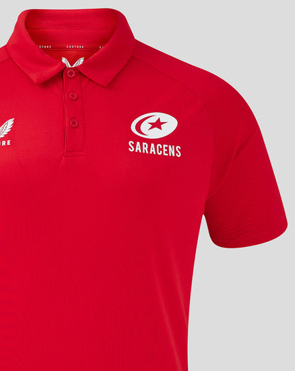 Close-up of red polo showing Castore logo on the left chest and Saracens logo on the right chest.