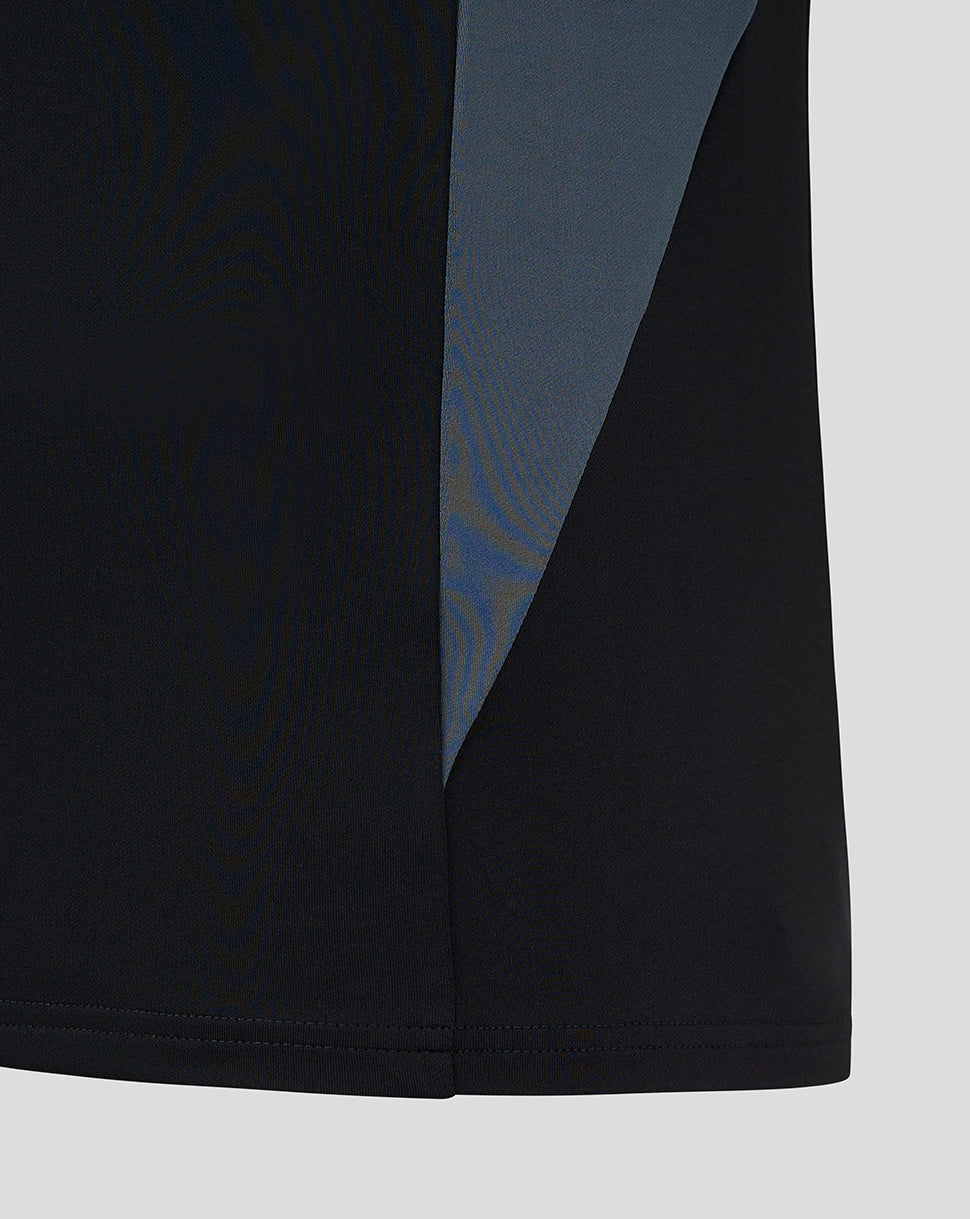 Side view of black training midlayer with a blue side panel and clean hem
