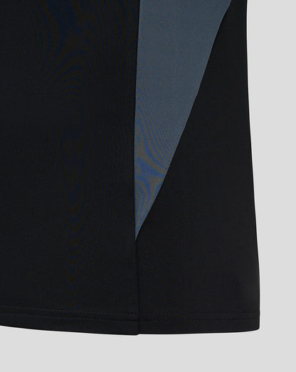 Side view of black training midlayer with a blue side panel and clean hem