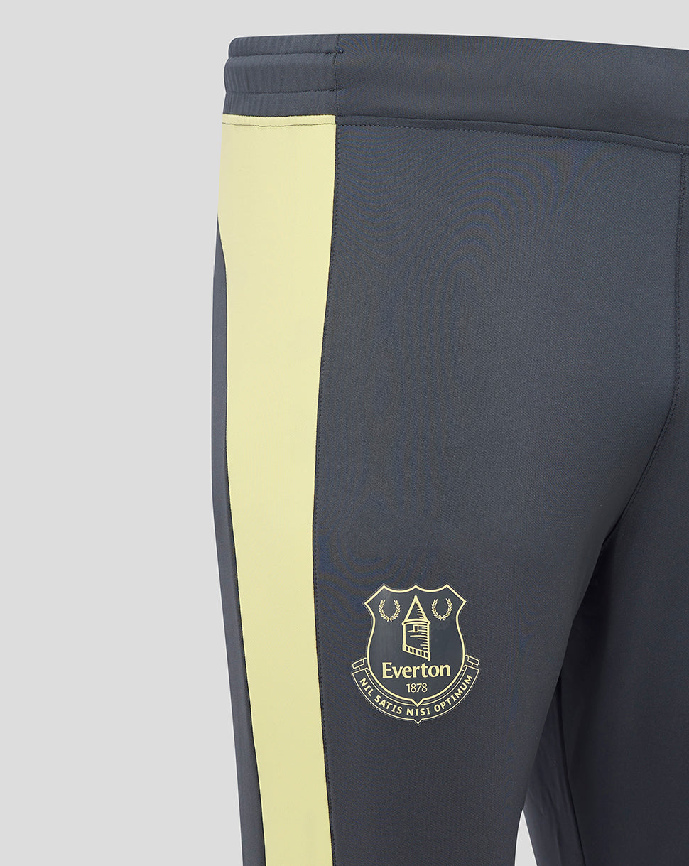 Close-up of navy Everton training pants with pale yellow side panel and club crest