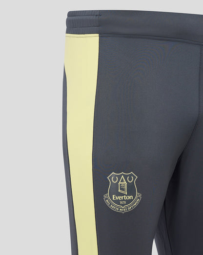 Close-up of navy Everton training pants with pale yellow side panel and club crest