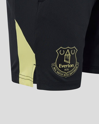 Close-up of black Everton shorts revealing gold crest badge near the hem and neon side panel
