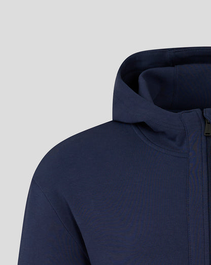 Close up of navy hooded travel jacket showing the hood and zipper at the collar area
