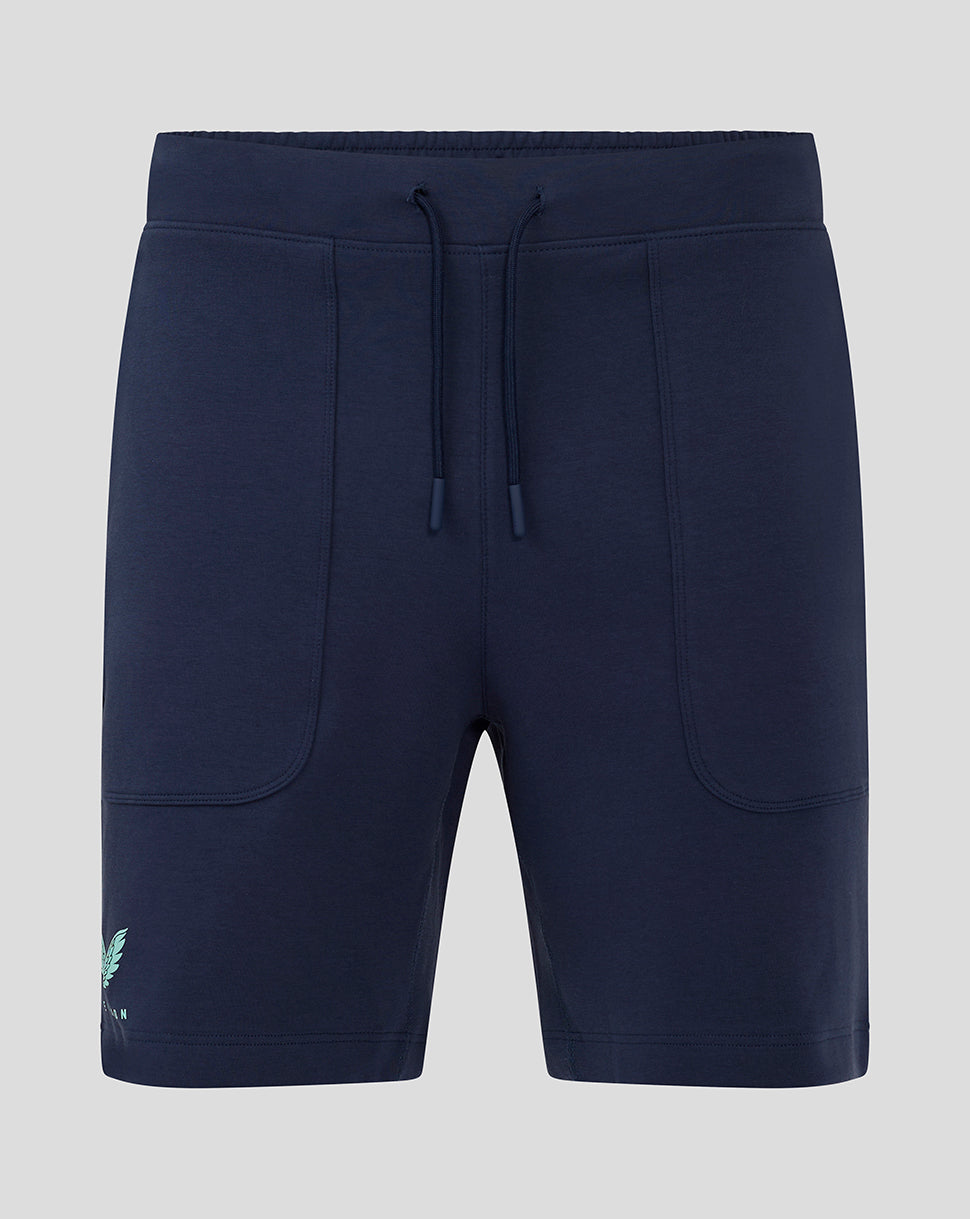 Front view of navy women's travel shorts with drawstring waist and curved patch pockets with logo at hem