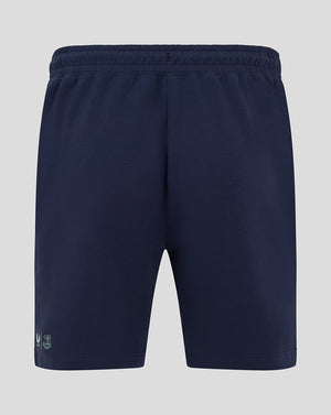 Back view of navy women's travel shorts with elastic waistband and small logo at hem