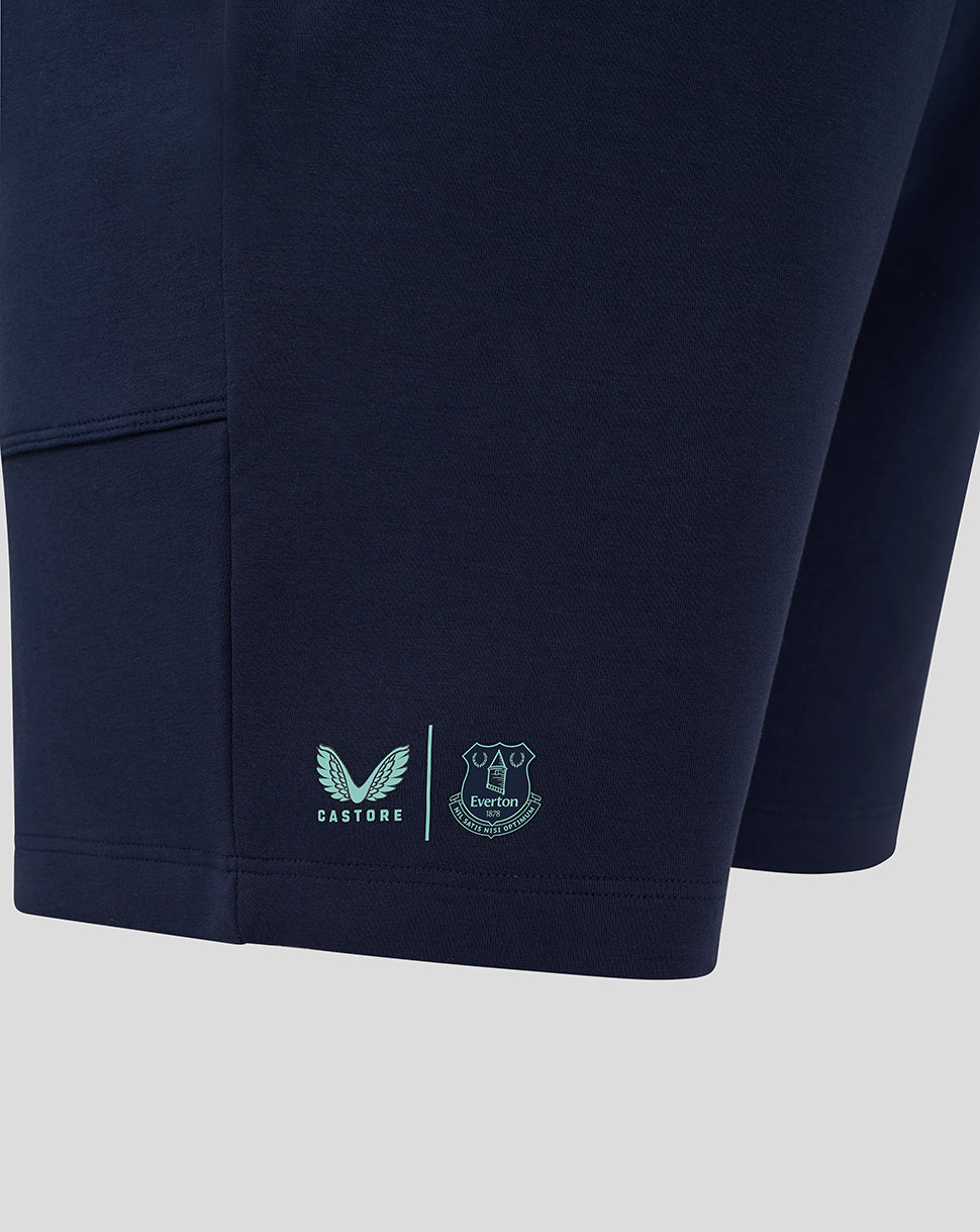 Lower portion of navy Everton travel shorts showing mint Castore and Everton logos on the hem.