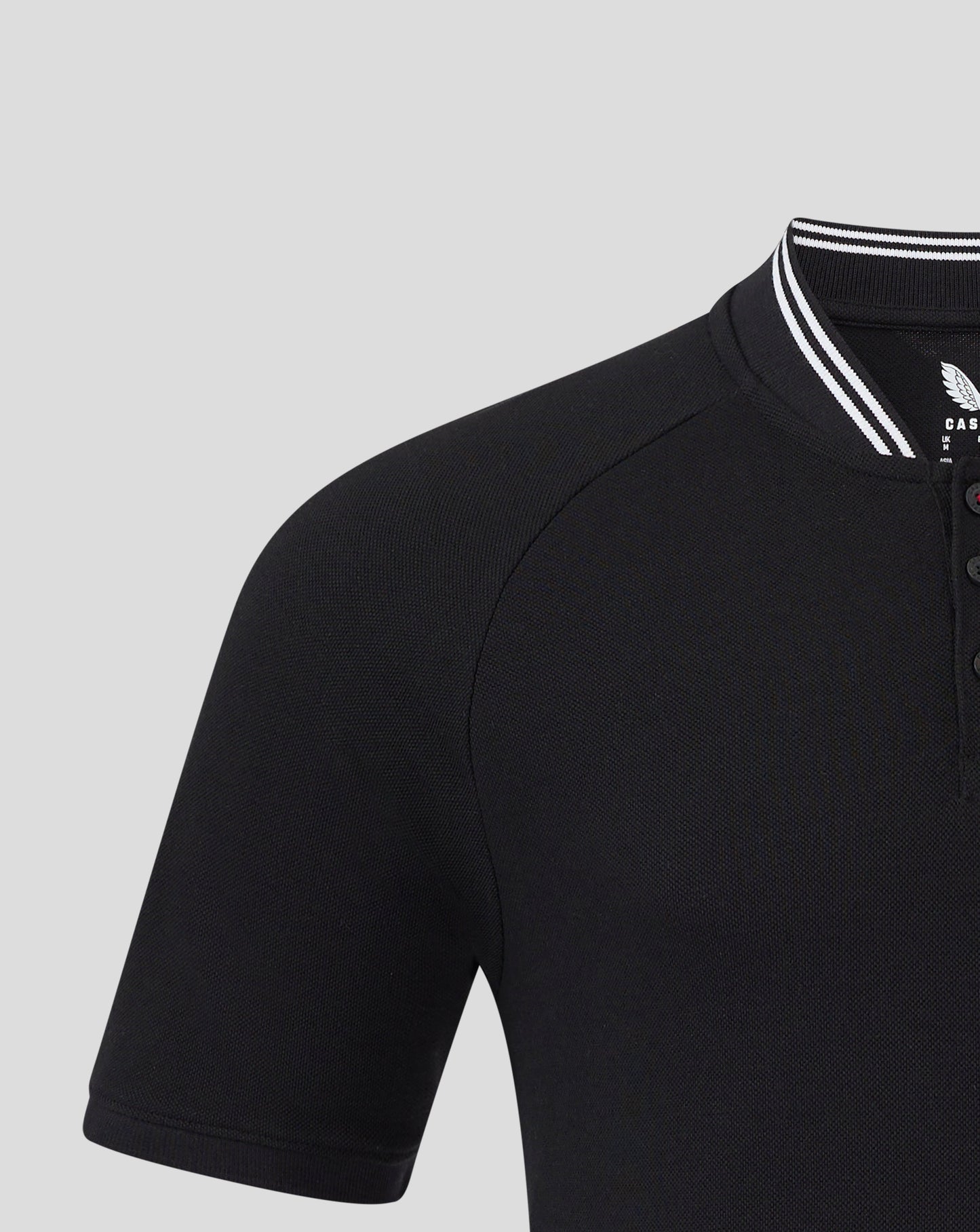 Left chest badge on black Rangers polo with white striped collar edge visible