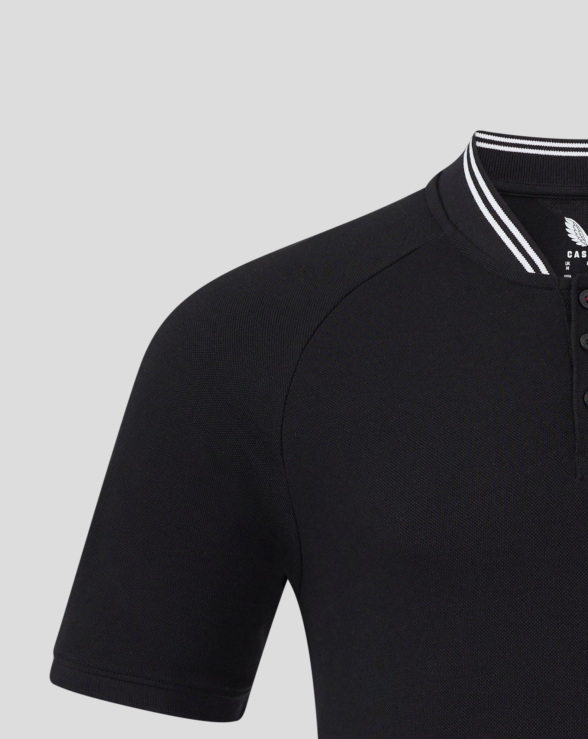 Left chest badge on black Rangers polo with white striped collar edge visible