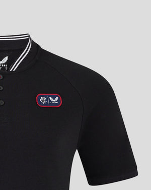 Close-up of black Rangers polo showing bomber collar with white stripes and front chest badge