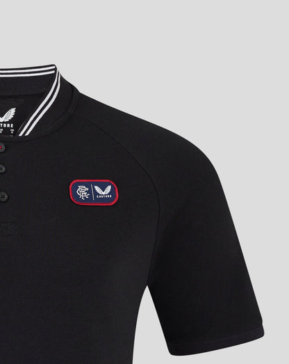 Close-up of black Rangers polo showing bomber collar with white stripes and front chest badge