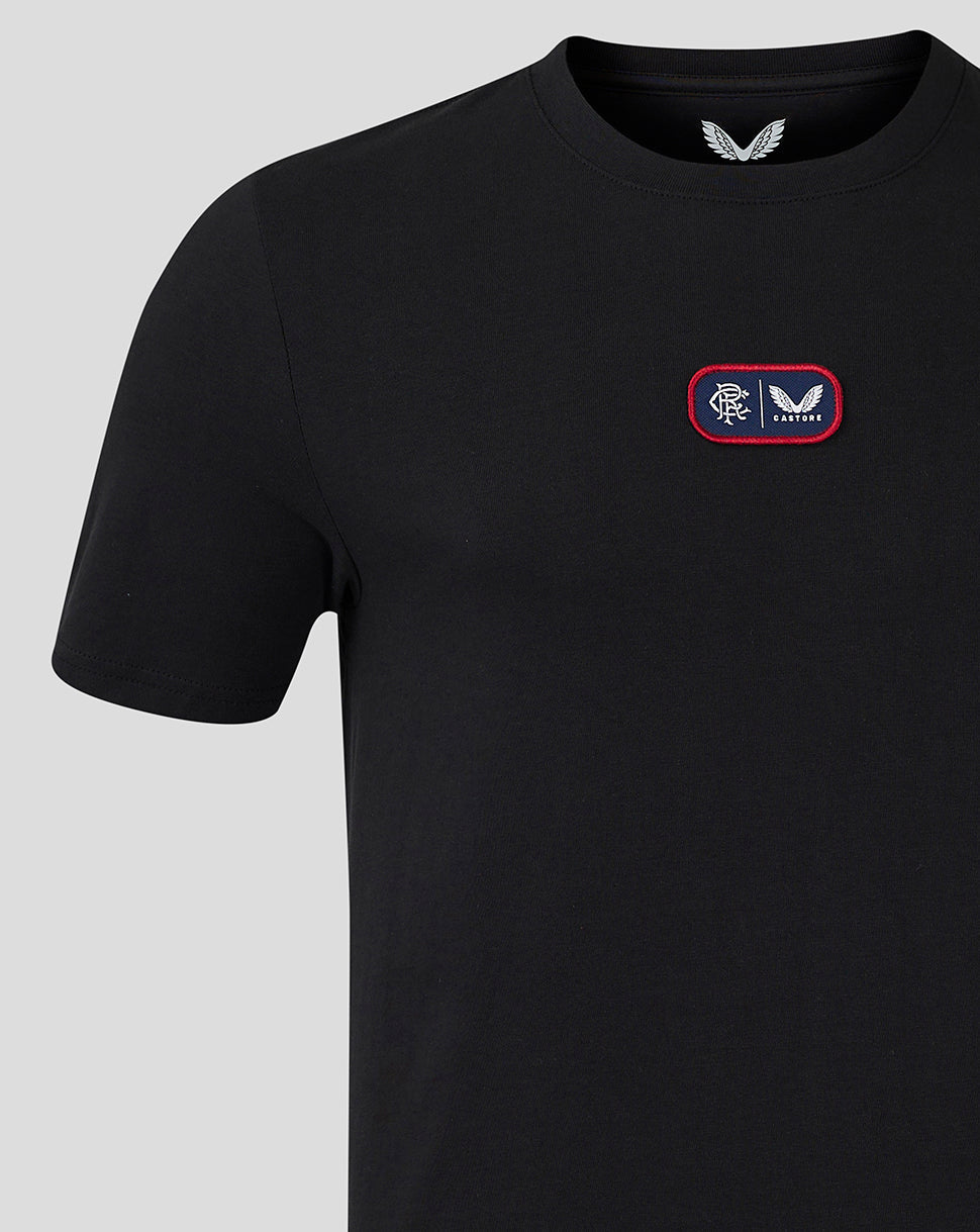 Close up of chest patch on black Rangers T shirt with crest and Castore logo on a red bordered patch