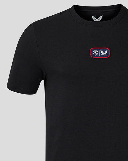 Close up of chest patch on black Rangers T shirt with crest and Castore logo on a red bordered patch