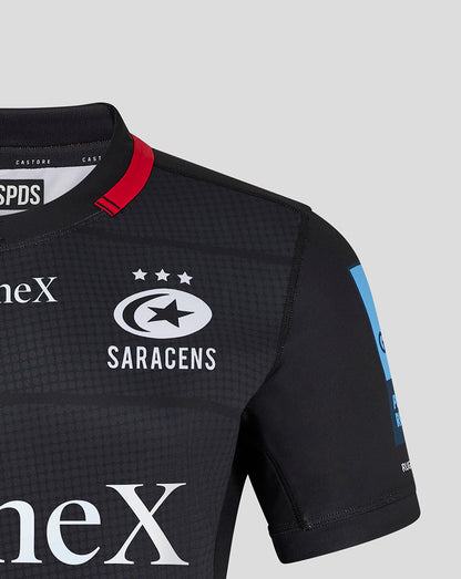 Chest close up of Saracens men's 24/25 home pro shirt showing Saracens crest and StoneX logo on dark fabric