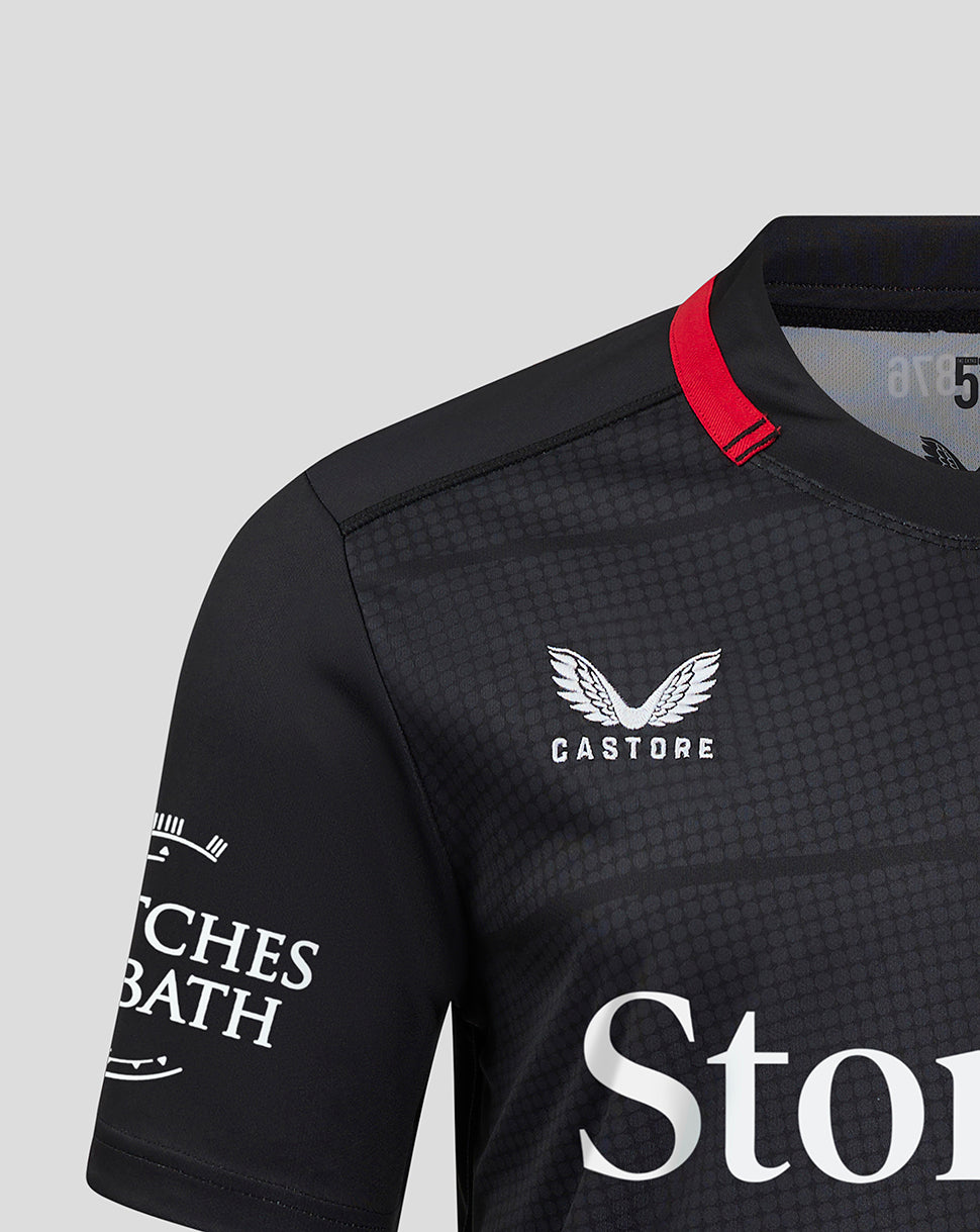 Saracens home shirt close up highlighting left chest club crest and right chest Castore branding with dark fabric and red collar tab.