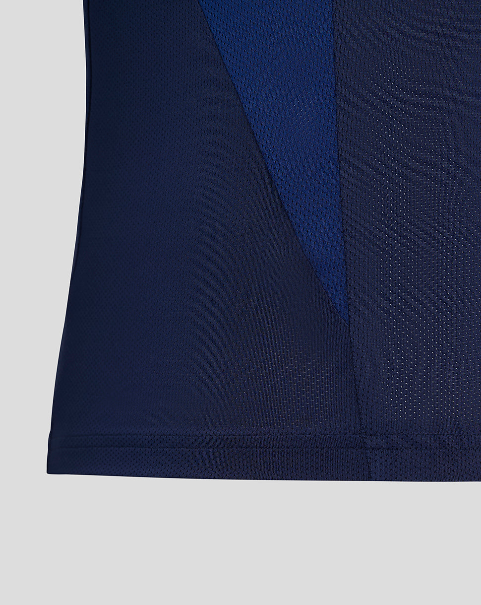 Close-up of navy Preston junior training T shirt fabric showing color-block panels and mesh texture