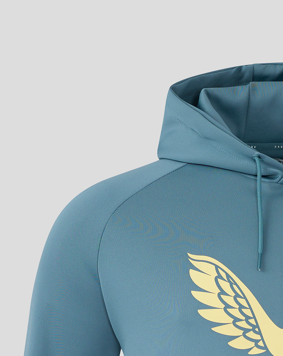 Close-up of the gold wing logo on the chest of the light blue Mansfield Town Travel Hoody.