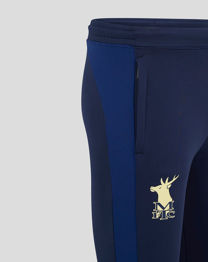 Close-up of navy Mansfield training pants showing a light crest on the front thigh and blue side panel.