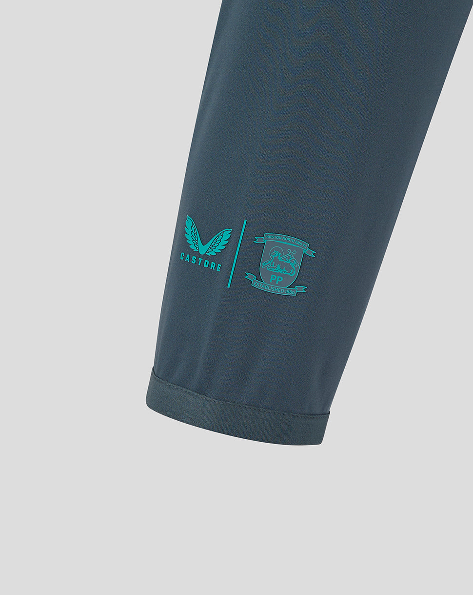Close-up of the lower sleeve displaying teal Castore logo and crest near the cuff.