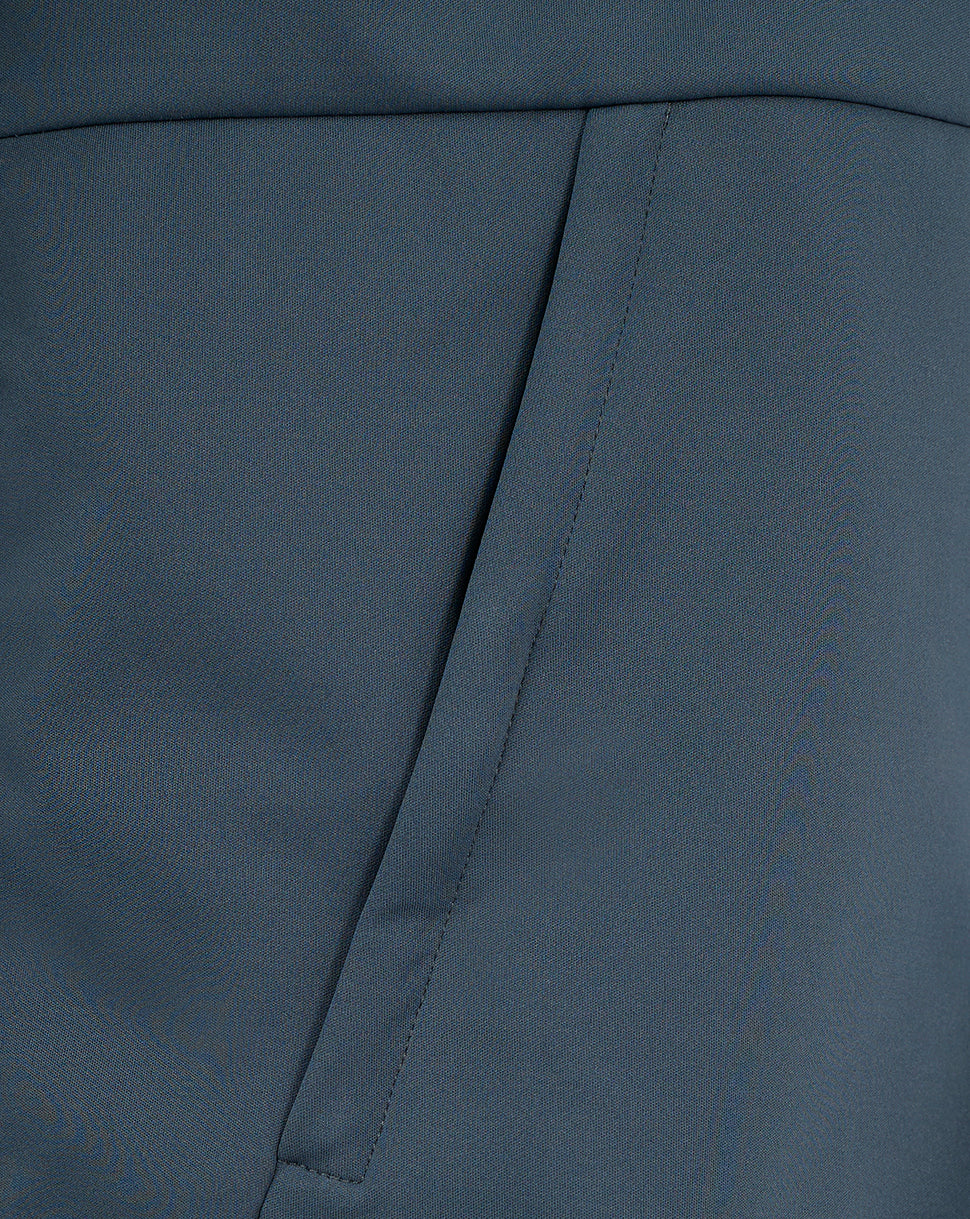 Close-up of blue softshell fabric and angled pocket seam on the Preston Women's Travel Jacket