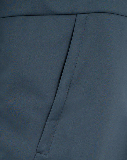Close-up of blue softshell fabric and angled pocket seam on the Preston Women's Travel Jacket