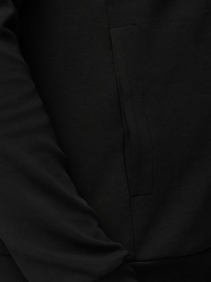 Close-up of black hoodie fabric showing the side pocket detail.