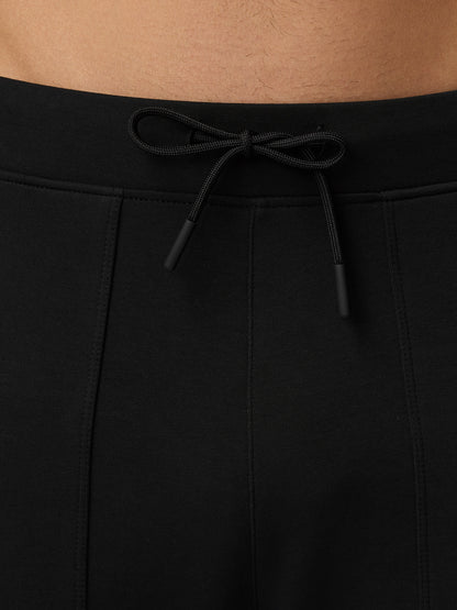 Back view of black Flex Travel Joggers waistband with external drawstrings tied.