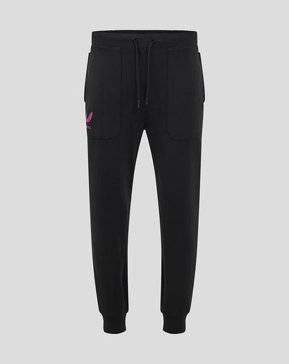 Front view of black Mk Dons travel pant with a drawstring waistband and a pink logo on the left thigh
