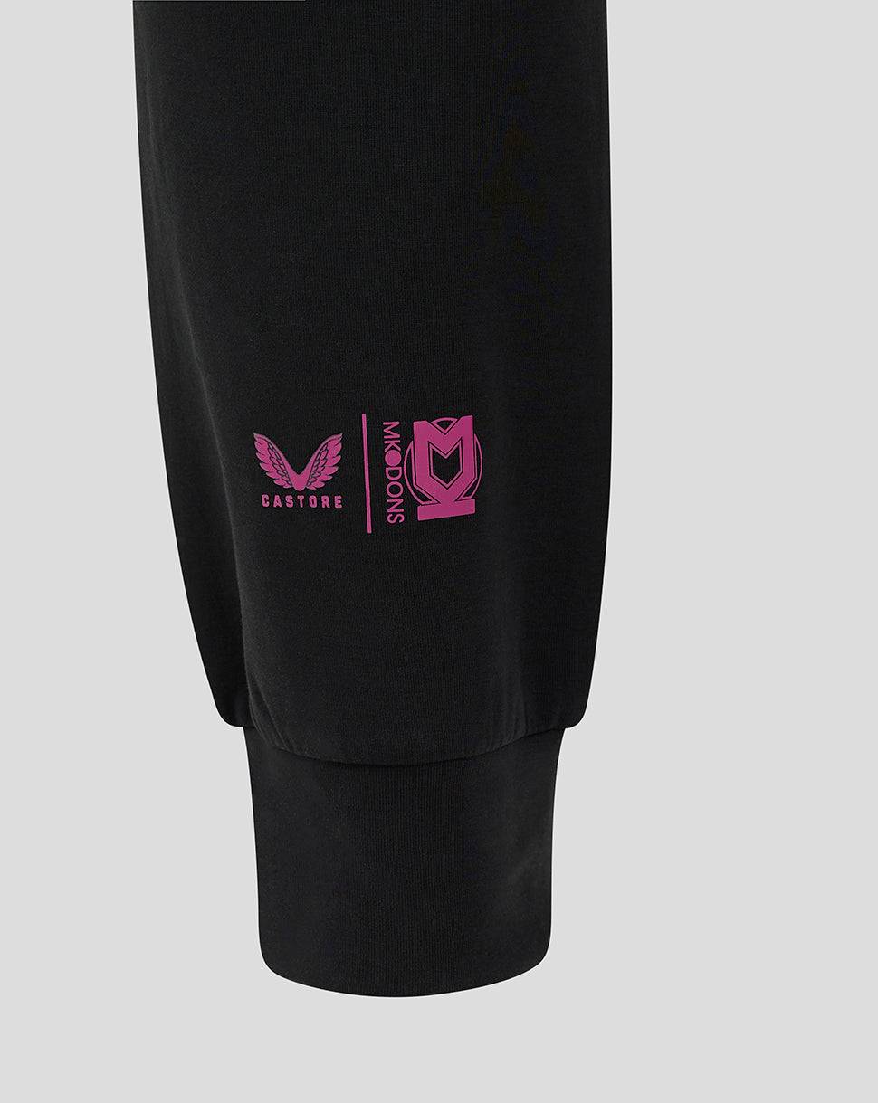 Close-up of the lower leg showing pink Castore and Mk Dons logos near the ankle cuff
